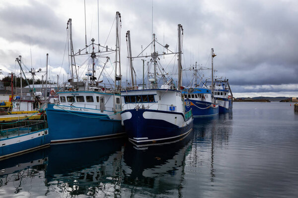 Twillingate, Newfoundland, Canada - October 15, 2018: Fishing boats parked at a marina during a cloudy morning.
