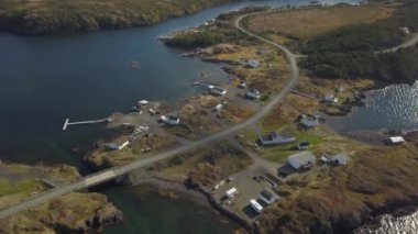 Aerial view of a small town on a rocky Atlantic Ocean Coast during a cloudy day. Taken in Herring Neck, Newfoundland, Canada.