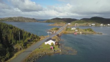 Aerial view of a small town on a rocky Atlantic Ocean Coast during a cloudy day. Taken in Herring Neck, Newfoundland, Canada.