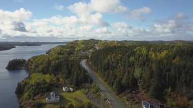 Aerial view of a small town on a rocky Atlantic Ocean Coast during a cloudy day. Taken in Herring Neck, Newfoundland, Canada.
