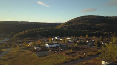 Aerial view of a small town on a rocky Atlantic Ocean Coast during a bright sunny sunrise. Taken in Little Bay, Newfoundland, Canada.
