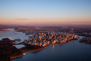 Aerial view of a modern Downtown City during a sunny winter sunset. Taken in Vancouver, British Columbia, Canada. clipart