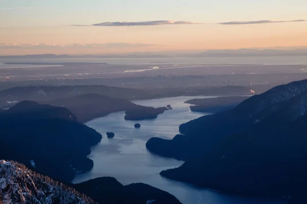 Aerial view of Deep Cove and Indian Arm during a sunny winter sunset. Taken North of Vancouver, British Columbia, Canada.