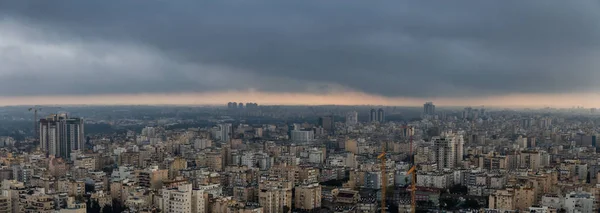 Aerial view of a residential neighborhood in a city during a cloudy sunrise. Taken in Netanya, Center District, Israel.