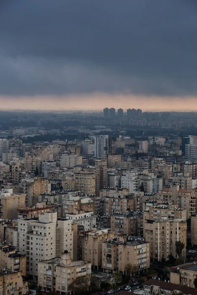 Aerial view of a residential neighborhood in a city during a cloudy sunrise. Taken in Netanya, Center District, Israel.