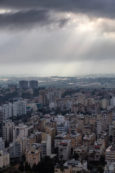 Aerial view of a residential neighborhood in a city during a cloudy sunrise. Taken in Netanya, Center District, Israel.