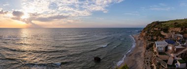 Beautiful Panoramic View on the Ocean Coast duing a vibrant sunset at the Apollonia Beach. Taken in Herzliya, Tel Aviv District, Israel. clipart
