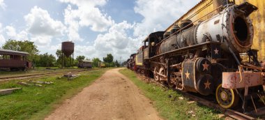 Trinidad, Küba - 08 Haziran 2019: Güneşli ve bulutlu bir günde eski bir trenle terk edilmiş bir tren istasyonunun görünümü.