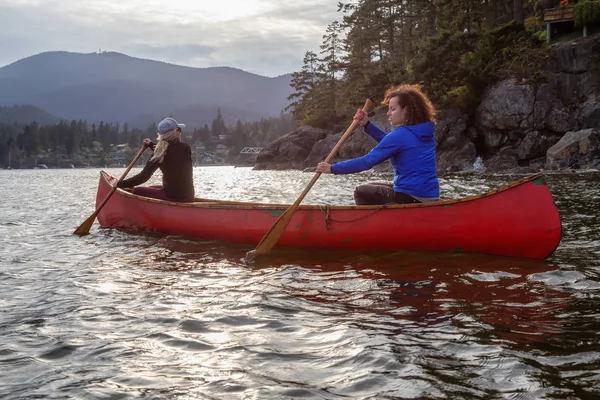 Couple Adventurous Female Friends Red Canoe Paddling Howe Sound Cloudy Stock Picture