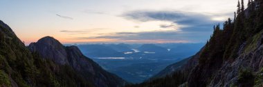 Beautiful Panoramic view of Canadian Mountain Landscape during a vibrant summer sunset. Taken at Mt Arrowsmith, near Nanaimo and Port Alberni, Vancouver Island, BC, Canada. clipart