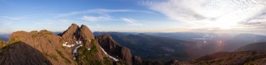 Beautiful Panoramic view of Canadian Mountain Landscape during a vibrant summer sunset. Taken at Mt Arrowsmith, near Nanaimo and Port Alberni, Vancouver Island, BC, Canada. clipart