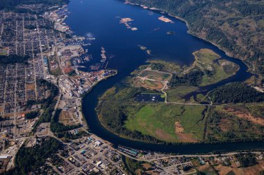Aerial view of a small industrial town, Port Alberni, on Vancouver Island during a sunny summer morning. Located in British Columbia, Canada. clipart