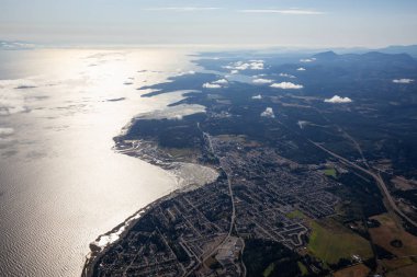 Aerial view of a small town, Parksville, on Vancouver Island during a sunny summer morning. Taken near Nanaimo, British Columbia, Canada. clipart
