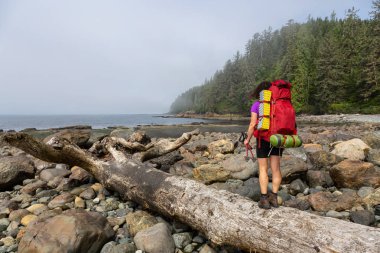 Maceracı kız güneşli ve sisli bir yaz sabahı sırasında Pasifik Okyanusu Kıyısında Bear Beach Juan de Fuca Trail yürüyüş. Port Renfrew yakınlarında çekilen Vancouver Adası, Bc, Kanada.