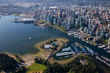 Aerial view of Coal Harbour and a modern Downtown City during a vibrant sunny morning. Taken in Vancouver, British Columbia, Canada. clipart