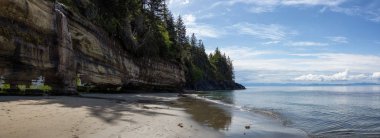 Beautiful Panoramic View of Mystic Beach on the Pacific Ocean Coast during a sunny summer day. Taken near Port Renfrew, Vancouver Island, BC, Canada. clipart
