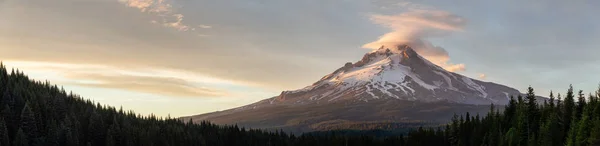 Beautiful Panoramic Landscape View of Mt Hood during a dramatic cloudy sunset. Taken from Trillium Lake, Mt. Hood National Forest, Oregon, United States of America.