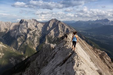 Maceracı Kız bulutlu ve yağmurlu bir gün boyunca kayalık bir dağkadar yürüyüş olduğunu. Lady Macdonald, Canmore, Alberta, Kanada'dan alındı.