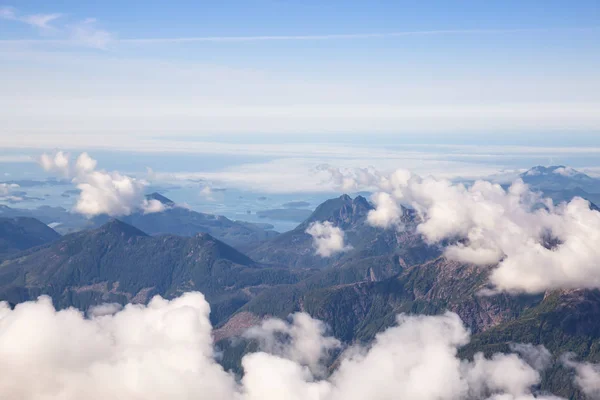Aerial Landscape View of Beautiful Coastal Mountains on the Pacific Ocean Coast during a sunny summer morning. Taken near Tofino and Ucluelet, Vancouver Island, British Columbia, Canada.