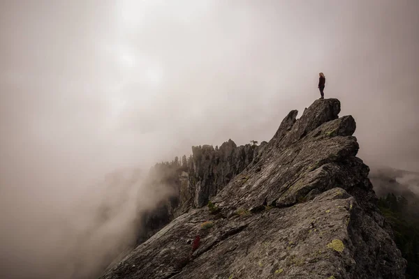 冒险的女孩站在一个崎岖的岩石山顶在一个多云的夏天的早晨 拍摄于加拿大不列颠哥伦比亚省北温哥华的皇冠山 — 图库照片