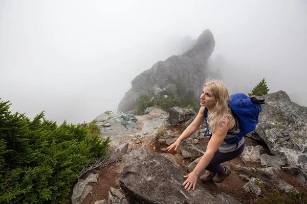 Maceracı Kız bulutlu bir yaz sabahı boyunca güzel bir kayalık dağ kadar dik bir iz kadar yürüyüş olduğunu. Crown Mountain'da çekilmiş, Kuzey Vancouver, Bc, Kanada.