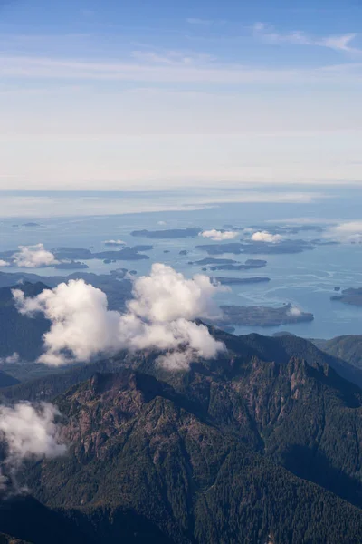 Aerial Landscape View of Beautiful Coastal Mountains on the Pacific Ocean Coast during a sunny summer morning. Taken near Tofino and Ucluelet, Vancouver Island, British Columbia, Canada.