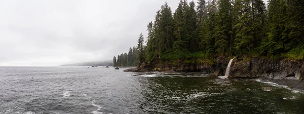 Sisli ve yağmurlu bir yaz gününde Juan de Fuca Trail şelale ile kayalık bir sahil güzel Panoramik Görünümü. Sombrio Beach'te, Port Renfrew yakınlarında, Vancouver Adası, Bc, Kanada.