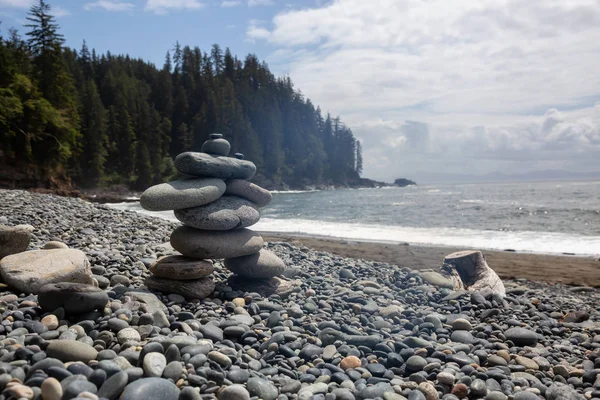 Stack of Rocks on a rocky coast along the Juan de Fuca Trail during a sunny and cloudy summer day. Taken at Sombrio Beach, near Port Renfrew, Vancouver Island, BC, Canada.