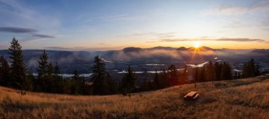 Beautiful Panoramic View of a Canadian City, Kamloops, during a colorful summer sunrise. Located in the Interior British Columbia, Canada. clipart