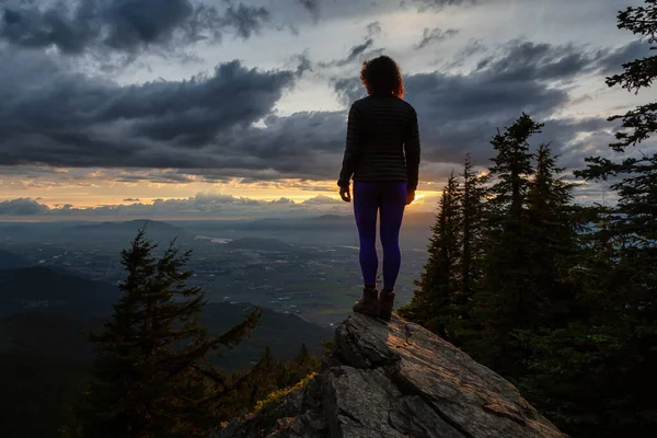 Fantasy Adventure Composite with a Man on the top of a Mountain Cliff — Stock Fotó