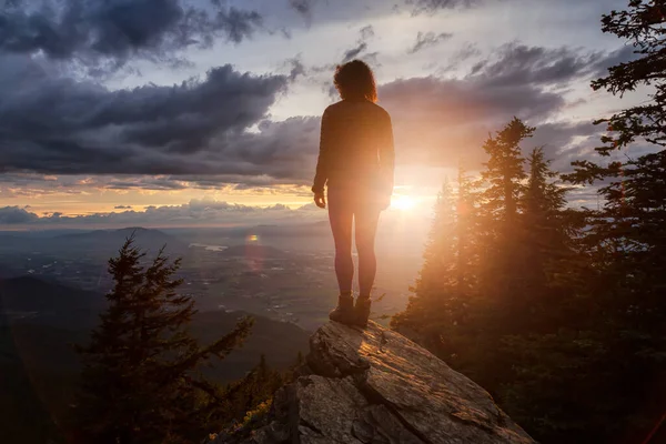 Fantasy Adventure Composite with a Man on top of a Mountain Cliff — Stock Photo, Image