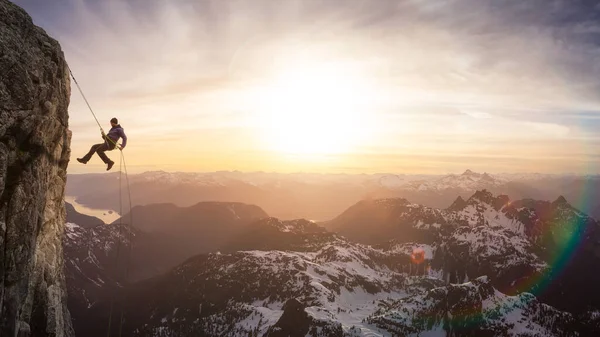 Epic Adventurous Extreme Sport Composite of Rock Climbing Man Rappelling from a Cliff. — Stok Foto