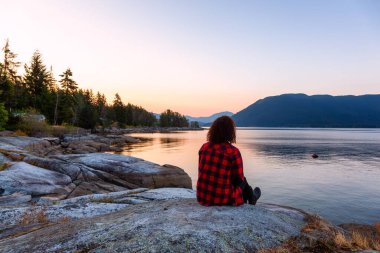 Okyanus kıyısında Huzurlu Gündoğumunu İzleyen Kız