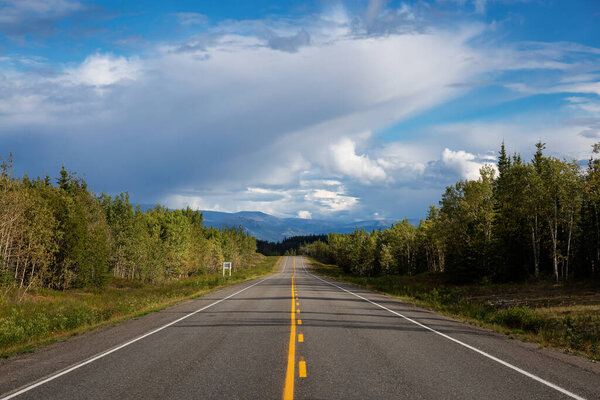 Scenic Road View of Klondike Hwy during a sunny and cloudy day.