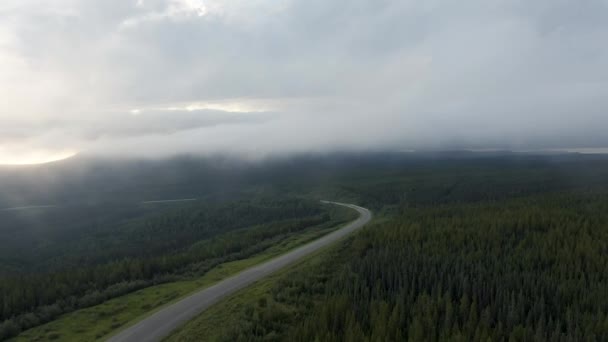 Beautiful View of Scenic Road from Above surrounded by Lush Forest, Clouds and Mountains — Stock Video