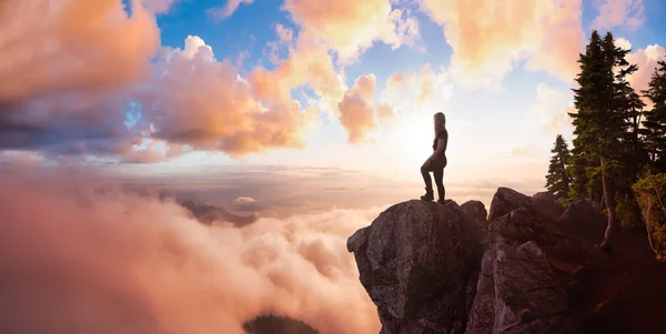 Äventyrlig kvinna Vandrare på toppen av ett berg täckt av moln — Stockfoto