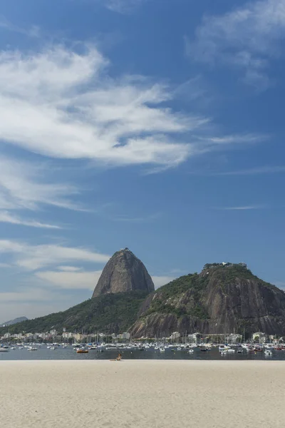 Landscape with view to the Sugar Loaf Mountain from Botafogo Beach on a sunny day with beautiful clouds and blue sky, Rio de Janeiro, Brazil