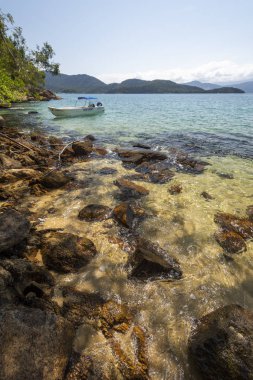 Güzel tropikal plaj manzara yeşil su, yemyeşil orman, mavi gökyüzü ve Ilha Grande, Costa Verde, Güney Rio de Janeiro, Brezilya için bir motorlu tekne