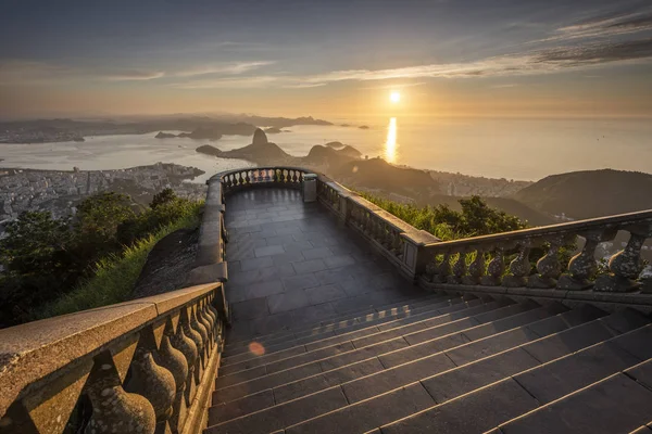 Beautiful landscape with a view to the city, mountains and an empty visitation area seen from Christ the Redeemer Statue (Cristo Redentor) on top of Corcovado Mountain (Morro do Corcovado) during the sunrise in Rio de Janeiro, Brazil