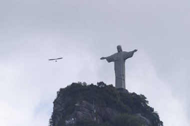 Hang glider İsa Kurtarıcı heykel (Cristo Redentor) uçan Corcovado Dağı (Morro Corcovado), Rio de Janeiro, Brezilya üzerine