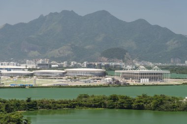 Beautiful landscape with view to olympic stadiums, lagoon and mountains on the back in Barra da Tijuca, Rio de Janeiro, Brazil clipart