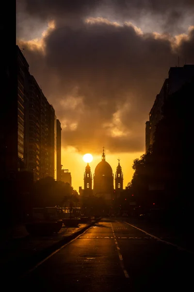 Beautiful view to empty downtown street and sun rising behind historic church building during covid-19 outbreak in Rio de Janeiro, Brazil
