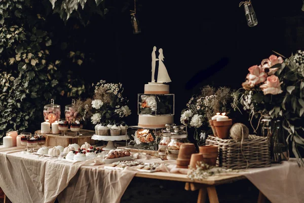 Конфетка Белый Свадебный Торт Украшен Цветами Стоящими Праздничном Столе Десертами — стоковое фото