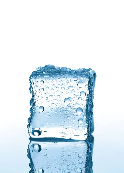 Single ice cube with water drops on white background with reflection