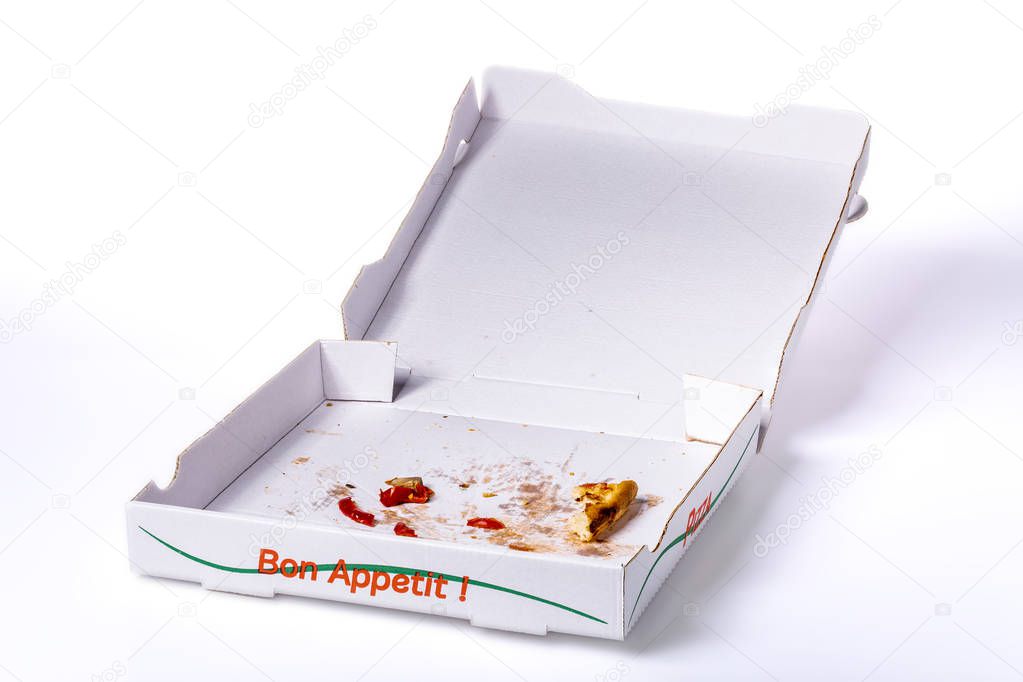 Pizza box with some leftovers on white background, clipping path included