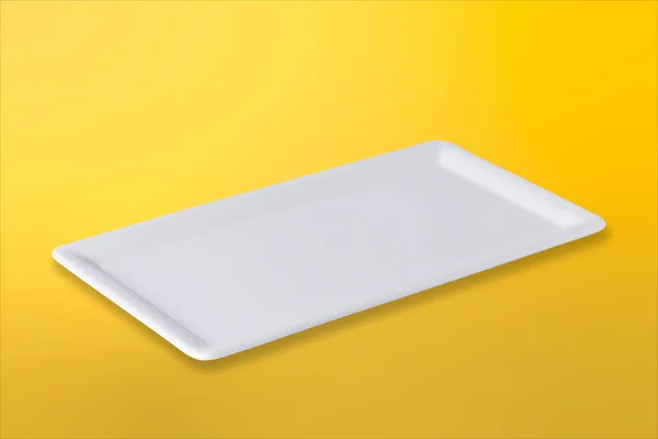 Empty white plate on gradient yellow orange  background — Stock Photo, Image