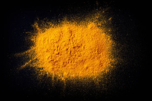 Curcuma turmeric spice powder on black background
