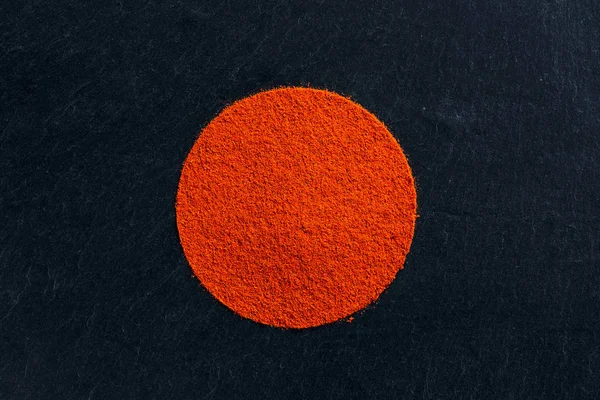 Paprika chili powder on dark background — Stock Photo, Image