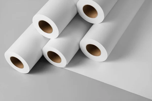 Blank white paper rolls mockup isolated on gray background