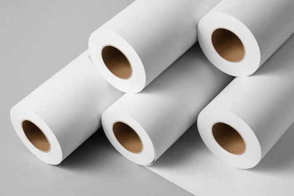 Blank white paper rolls mockup isolated on gray background